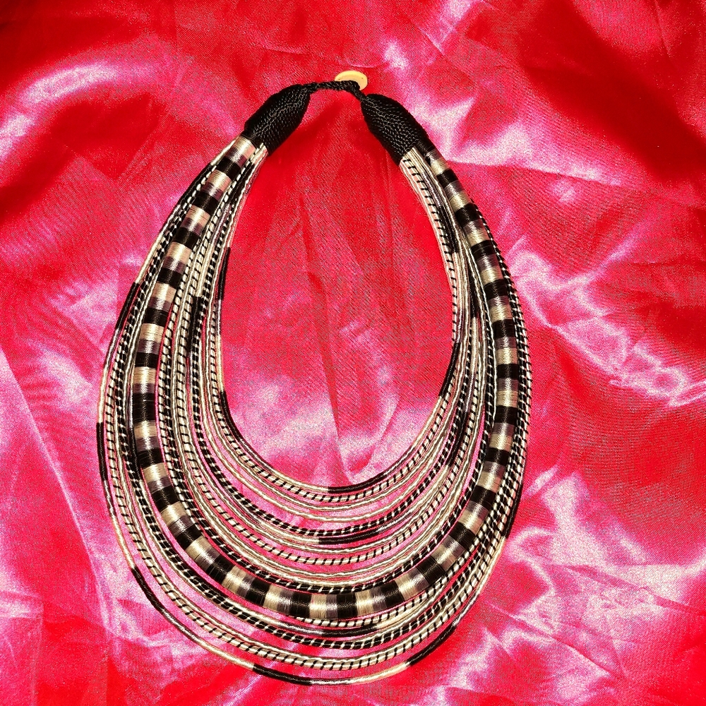 White, silver and black bib